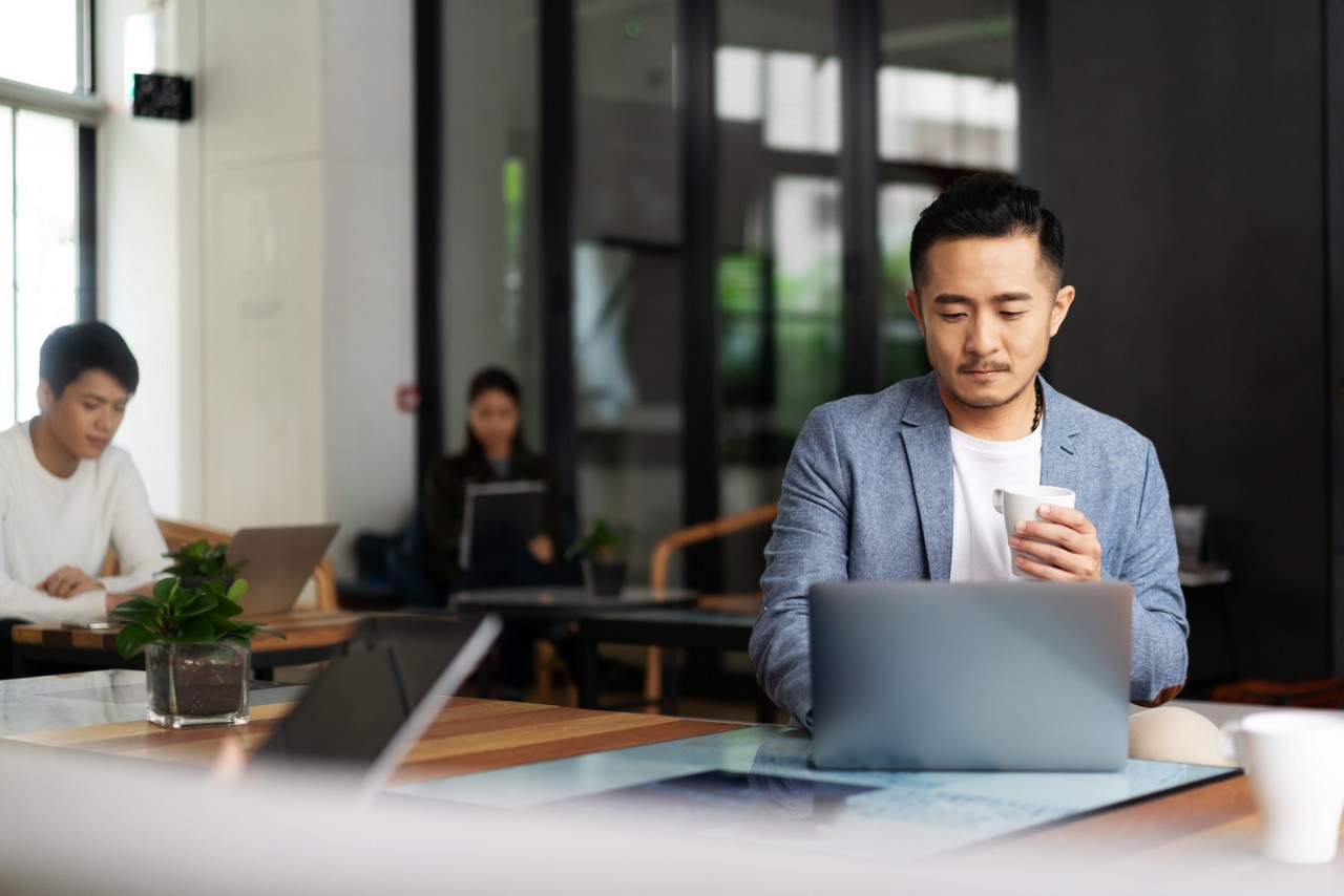 young chinese business people working with laptop