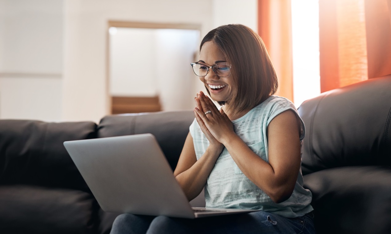 Cropped shot of an attractive young woman using a laptop at home